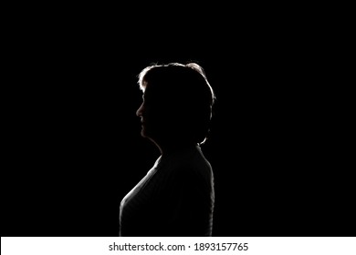 dark black background with silhouette of male woman  - Powered by Shutterstock