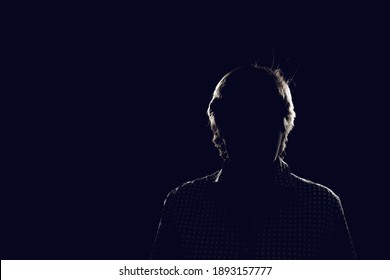 dark black background with silhouette of male woman 