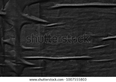 Dark black grey creased crumpled paper background surface old torn ripped posters scary grunge texture backdrop   