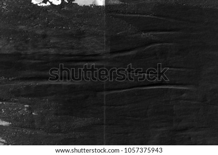 Dark black grey paper background creased crumpled surface old torn ripped posters placard grunge textures  