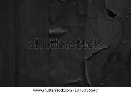 Dark black grey paper background creased crumpled surface / Old torn ripped posters scary grunge textures backdrop 