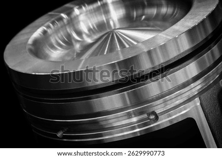 Dark black large piston engine. Piston new and shiny. Image has industrial and mechanical mood, service repair car concept background