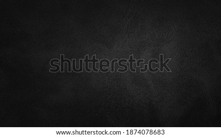 dark black leather texture closeup with detailed background. black abstract uneven grunge background texture of interior classic chamois leather fabric. 