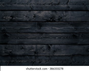 Dark Black Wood Texture Background Viewed From Above. The Wooden Planks Are Stacked Horizontally And Have A Worn Look. This Surface Would Be Great As Design Element For A Wall, Floor, Table Etc.
