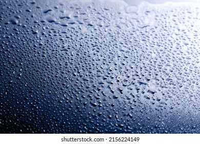 Dark blue abstract background with doplets of water.