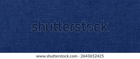 Dark blue background from a textile material. Fabric with natural texture. Cloth backdrop.