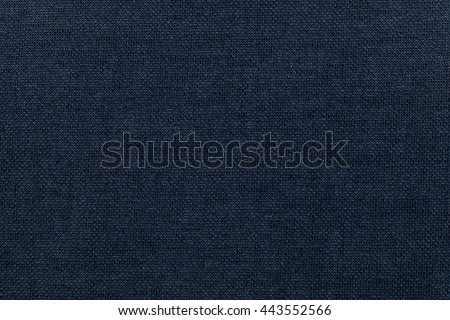 Dark blue background from a textile material. Fabric with natural texture. Cloth backdrop.