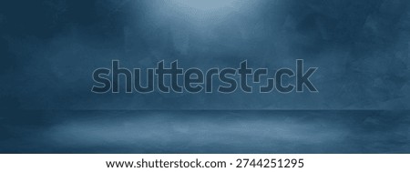 Dark blue cement studio background with textured wall floor stage soft spotlight and atmospheric smoke. Elegant podium for product display luxury gallery or cinematic presentation