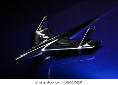 Dark Blue Chevrolet Bel Air Chrome Hood Ornament Shot Against Dark Background.