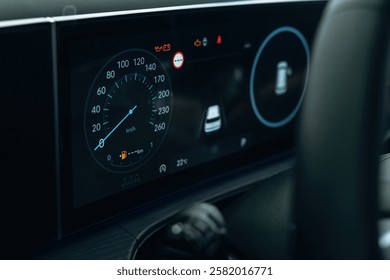 Dark and blue colors. Detailed close up view of speedometer, front panel.