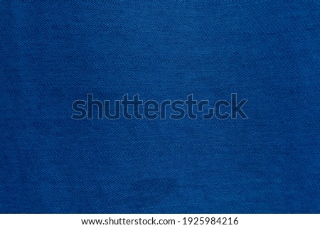 Dark Blue denim fabric texture background, the strong cotton cloth used especially to make jeans.