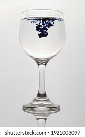 Dark Blue Dye Poured Into A Wineglass