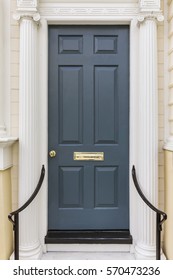 Dark Blue Front Door With A Gold Colored Mail Slot