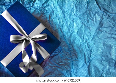 The Dark Blue Gift Box With  Ribbon Decoration On Polka Blue Paper , Happy Father's Day Concept , Top View And Overhead Shot , Right Copy Space Background