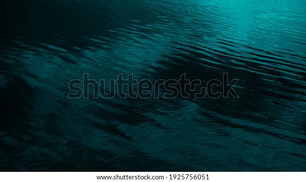  Dark blue green abstract background. Reflection of
light on a smooth surface of water with small waves. Tidewater
green background with copy space for design. Web banner.         
