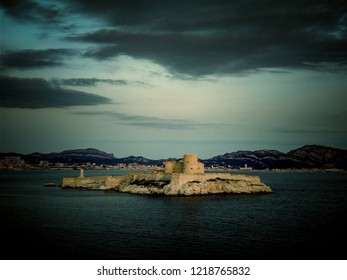 Dark blue landscape with Chateau d'if prison where Alexander Dumas imprisoned count Monte Cristo in his novel, Marseille, France, view from iles de Frioul.