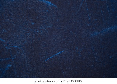 Dark blue material with subtle, lighter blue markings and grain.
