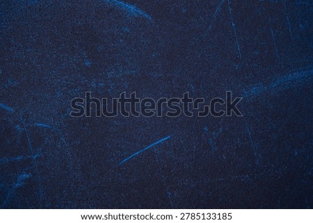Dark blue material with subtle, lighter blue markings and grain.