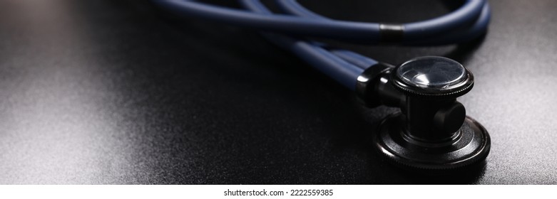 Dark Blue Medical Stethoscope On Black Surface