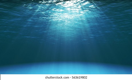 Dark blue ocean surface seen from underwater. Abstract Fractal waves underwater and rays of sunlight shining through