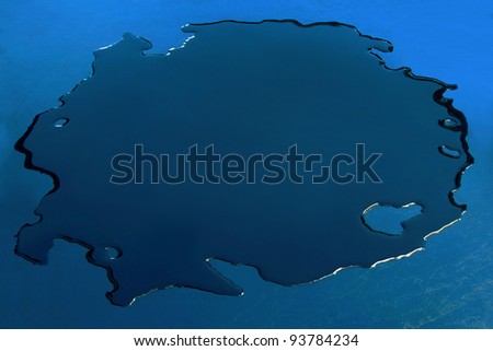 Dark blue puddle. Blue background.