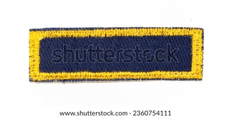 Dark blue rectangular patch with gold trim.