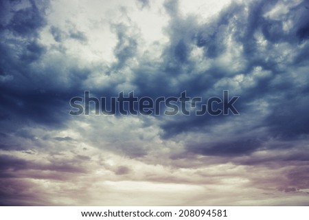 Dark blue stormy cloudy sky natural photo background with Instagram toned effect