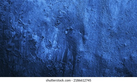    Dark blue texture. Old painted wall. Close-up. Gradient. Grunge background with space for design. Toned rough metal surface.                            