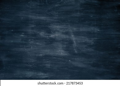 Dark blue textured wooden background with an aged look and with scratches and dents.