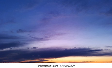 dark blue and violet sky with orange sunset at evening