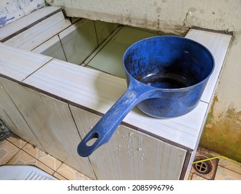 A Dark Blue Water Pitcher Above A Bathroom Tub