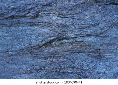 Dark blue wet slate background or texture.