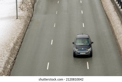 Dark BMW I I3 With An Electric Powertrain Using Rear Wheel Drive Drives In The Highway. Riga, Latvia, 02.09.2022