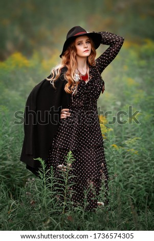 Similar – Blonde woman with hat taking a walk in the forest at sunset with the sun in the background.