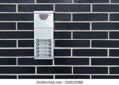 Dark Brick Facade With Doorbell Panel To Call Each Floor