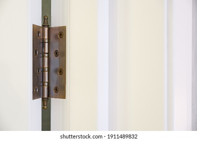 
Dark Bronze Hinge On The White Door 