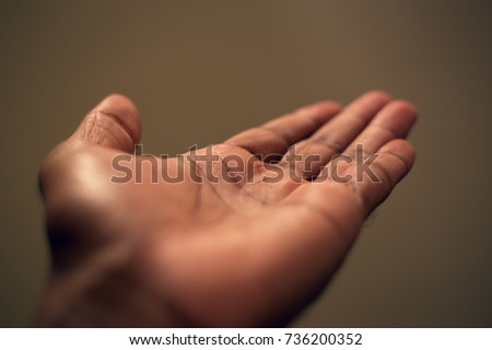 Dark brown asian one empty human hand palm creases showing direction or reading begger.