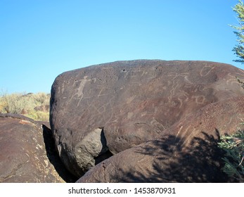 Dark Brown Boulder With Historical Archaeological Petroglyph Rock Carvings At Celebration Park In Idaho.