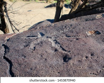 Dark Brown Boulder With Historical Archaeological Petroglyph Rock Carvings At Celebration Park In Idaho.