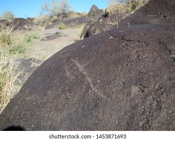 Dark Brown Boulder With Historical Archaeological Petroglyph Rock Carvings At Celebration Park In Idaho.