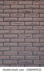 Dark Brown Brick Veneer Wall With Black Mortar Joints