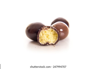 Dark Brown Chocolate Balls And Half With Crisp Filling Over White Background