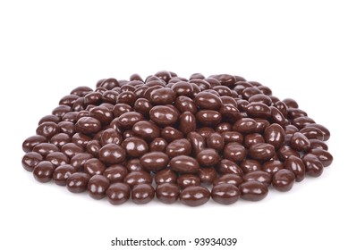 Dark brown dragee, chocolate covered nuts, isolated on white background