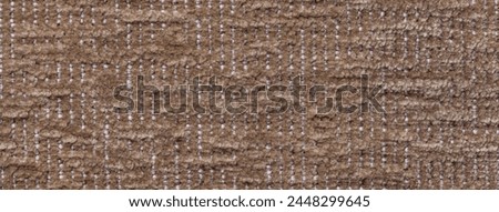 Dark brown fluffy background of soft, fleecy cloth. Texture of bronze plush furry textile, closeup.