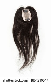 A Dark Brown Hair Topper With Two Hair Clips For Attachment. Set Against A White Background.