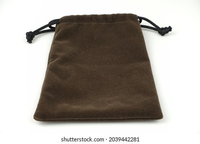 A Dark Brown Pouch With Black String Isolated On A White Background.