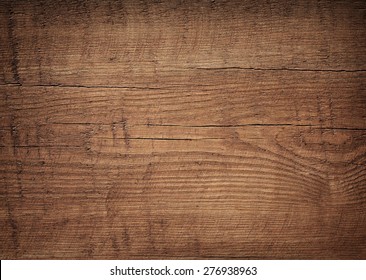 Dark brown scratched wooden cutting board. Wood texture - Shutterstock ID 276938963
