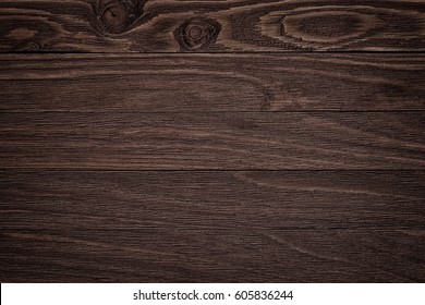 Dark brown scratched wooden cutting board. Wood texture 