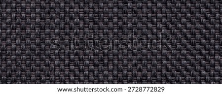 Dark brown woven textile texture background, macro. Black fabric material backdrop with weave pattern.