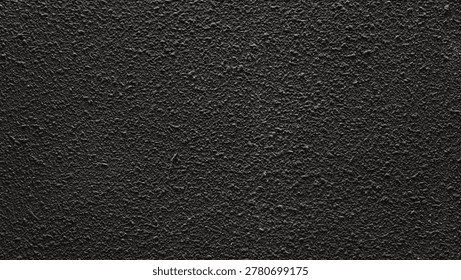 Dark bumpy wall texture creating an abstract rough surface background